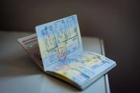 An open passport full of visa stamps