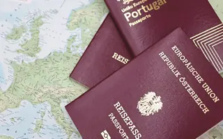 Two passports lying on a map of Europe